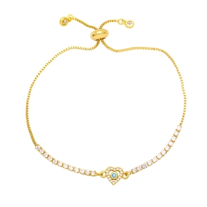 Macro view of adjustable gold heart bracelet with blue stone and cubic zirconia details
