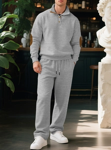 Detail of grey men's knit set featuring vertical texture and quarter-zip collar design