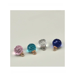 Macro detail of four faceted 10mm glass crystal pendants in pink blue and clear colors