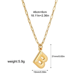 Detail view of golden bubble letter B pendant on paperclip chain with size measurements
