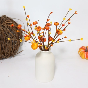 Artificial pumpkin berry branches in a white vase for autumn harvest and fall decoration