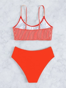 Rear view of striped bikini top with adjustable straps and red high waisted bottoms