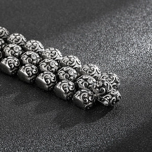 Macro shot of vintage silver steel bracelet beads with intricate hollow filigree patterns