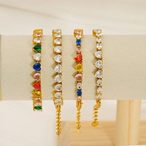 Detail view of multi-colored heart-shaped zircon bracelets with golden metal finish