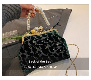 Detail showing dark green leopard velvet shell bag with pearl handle and golden chain