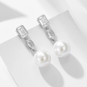 Elegant S925 silver earrings with square zircon and large white pearls on a white podium