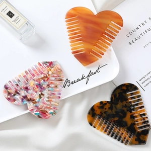 Chic heart-shaped acetate hair combs in amber, floral, and tortoiseshell patterns