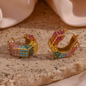 Detail of gold-plated titanium steel C-hoop earrings with colorful crystals on stone