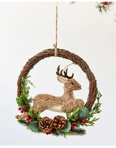 Detail of Christmas wreath with a rattan ring, reindeer sculpture, and red berries