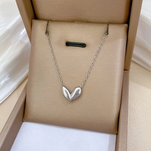 Macro detail of tulip petal pendant on thin titanium steel chain in jewelry box