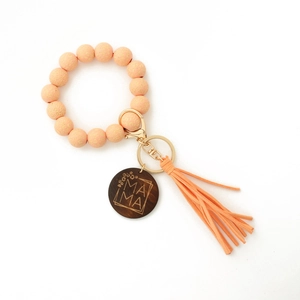 Detail of leopard print silicone beads with engraved MAMA wood tag and suede tassel keychain