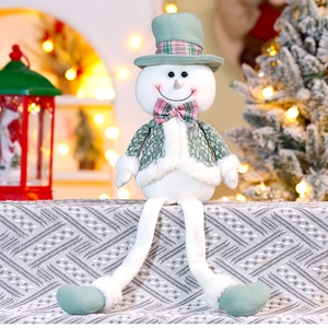 Detailed view of a plush Christmas snowman doll with green hat and dangling legs decor