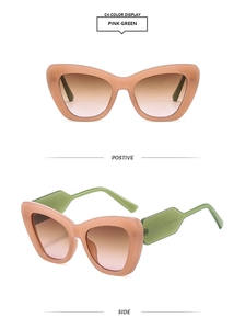 Detail view of pink and green contrast cat eye sunglasses with gradient brown lenses