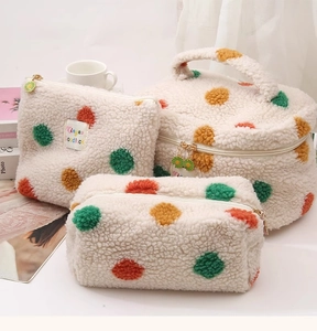 Detailed close-up of fluffy cream lamb wool cosmetic bag set with colorful 3D plush dots