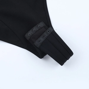 Detail of the black bodysuit crotch with three-row adjustable metal buckle closure