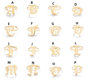Collection of retro Gothic gold initial rings from A to P in a grid layout