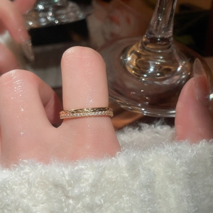 Close-up of thin 18k gold plated ring with micro-pave zircons worn on finger