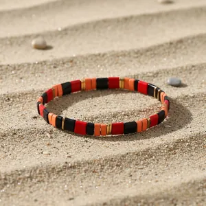 Macro view of colorful geometric enamel tiles on bohemian elastic stretch bracelets