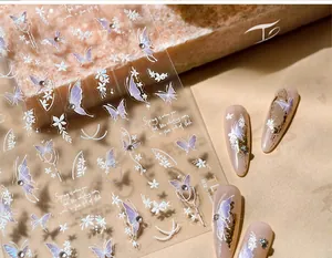 Detailed macro view of 3D butterfly nail art stickers with purple pearlescent finish