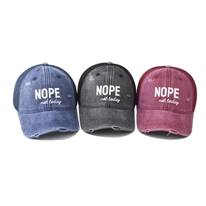 Distressed mesh trucker hats in navy, charcoal, and burgundy with NOPE print