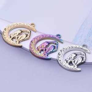 Detail of crescent moon necklaces in gold, silver and rainbow finish with Celtic patterns