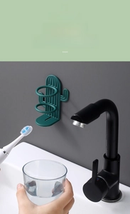 Detail showing wall-mounted green cactus toothbrush holder with water drainage design