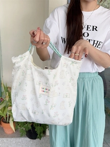 Floral canvas tote bag with rabbit print and blue rope handles for daily commuting
