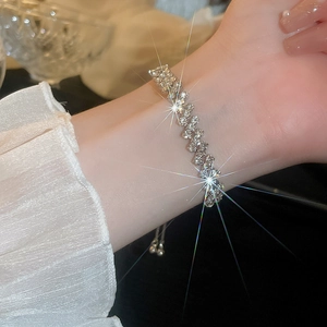 Close-up of a silver geometric bracelet with sparkling zircons worn on a wrist