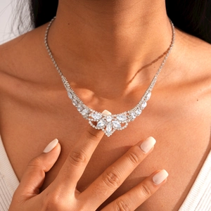 Close-up of elegant silver necklace set with teardrop crystals on a model's neck