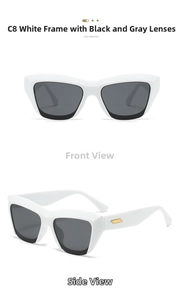 Detail view of white cat-eye sunglasses with golden parallel stripes and dark lenses