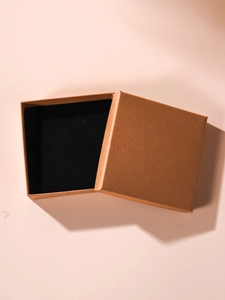Detail view of square kraft paper jewelry box with black sponge insert and lid