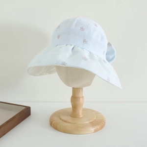 Detail of light blue floral sun hat with ruffle brim and large bow for girls