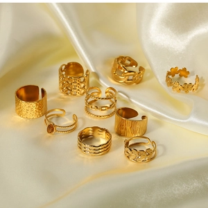 Set of 10 vintage gold rings with boho styles on elegant cream silk background