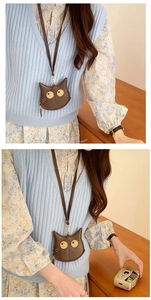 Detailed view of brown cat shaped PU leather coin purse with neck strap and gold zipper