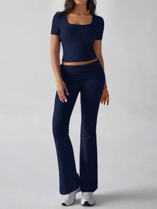 Full view of women's navy blue Y2K two-piece set with cropped tee and flared trousers