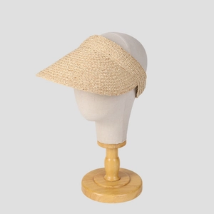 Natural raffia open-top sun hat with wide brim on a mannequin head for summer protection