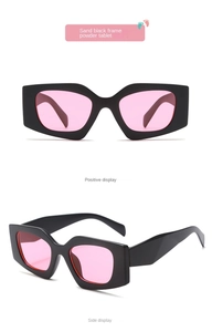 Detailed view of sand black geometric cat-eye sunglasses with translucent pink lenses