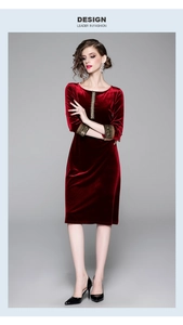 Dettaglio dei ricami vintage sui polsini di un abito aderente in velluto rosso scuro