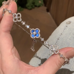 Exquisite silver-toned clover bracelet with zircon pavé and blue enamel in macro view