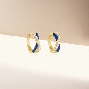 Detail of gold hoops with deep blue enamel and micro-pave white zircon crystals