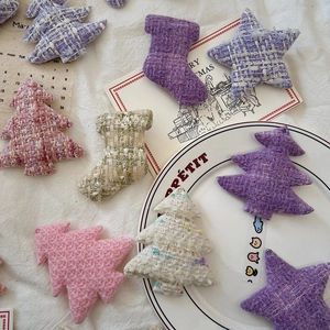 Detail of tweed fabric Christmas ornaments with gold wire weaving and pastel colors