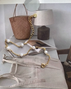 Detailed shot of S925 silver gold-plated bead chain with pearls and hallmark tag