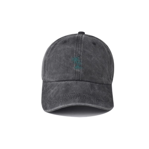 Detailed close-up of green coconut tree embroidery on a vintage grey washed baseball cap