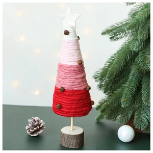 Detail of wool felt Christmas tree with gradient yarn, white star and rustic bells