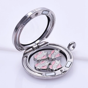 Detailed view of an open silver round locket charm containing four pink MOM heart inserts
