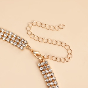 Detail of gold choker chain with three rows of rhinestones and adjustable lobster clasp