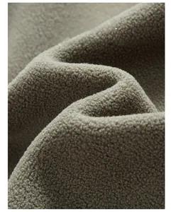 Close-up of soft khaki fleece fabric showing delicate texture and flexible elastic fibers