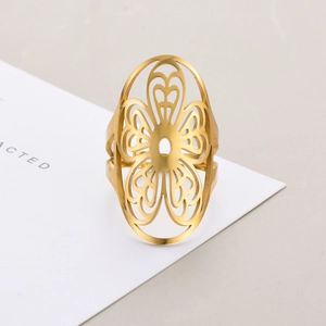 Macro shot of gold stainless steel ring featuring vintage cutout floral hollow pattern