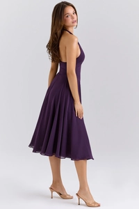 Detail of elegant backless halter neck design on a purple pleated chiffon midi dress