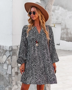 Detail of loose leopard print long sleeve dress featuring V-neck and ruffled hem design